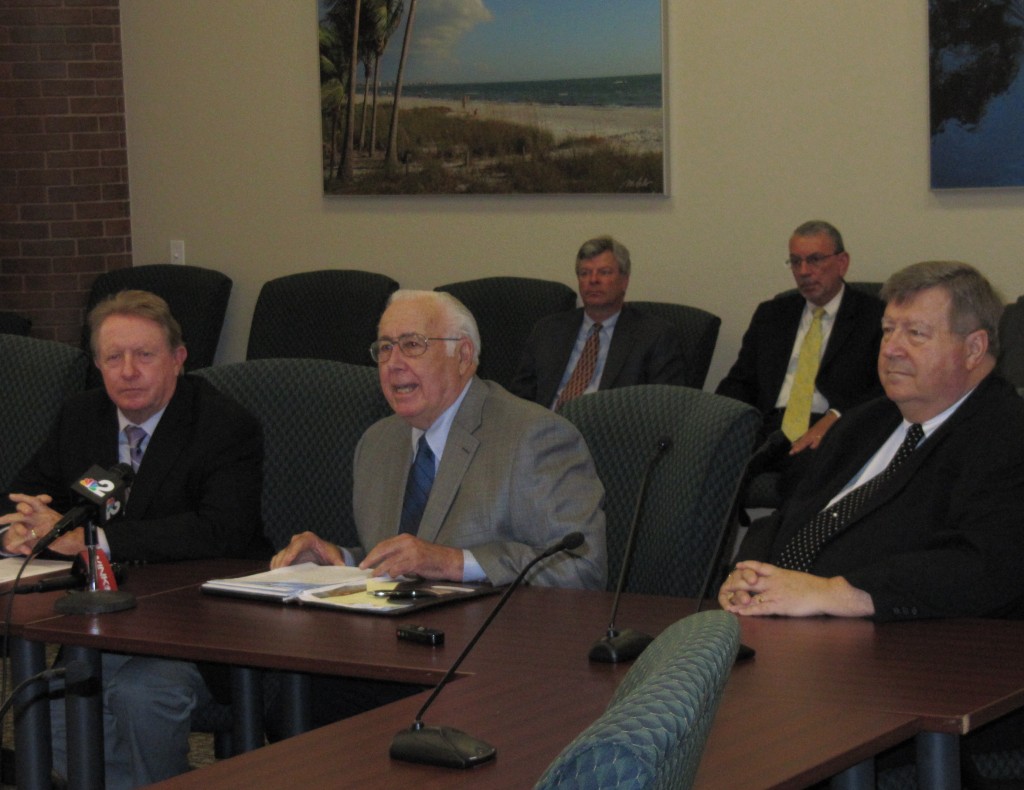 Seated left to right Lee County District 3 Commissioner Larry Kiker, Village of Estero Mayor Nick Batos, Interim Village Manager Peter Lombardi participated in the press conference on August 4. Seated in the second row are Lee County Assistant County Manager Pete Winton and Lee County District 1 Commissioner Frank Manning.